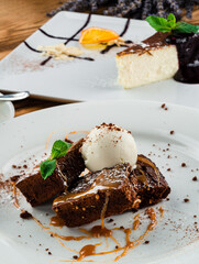 Chocolate pecan brownies with chocolate sauce, ice cream