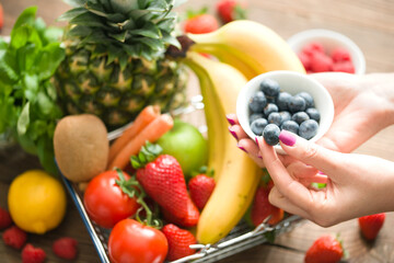 Eating fruits and vegetables concept with basket full of healthy and organic goods