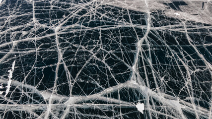 Deep Blue Cracked Ice. Top Aerial View. Frozen Texture of Baikal Lake in Russia