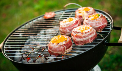 Making home made Beer Can Bacon Burgers on barbecue grill.