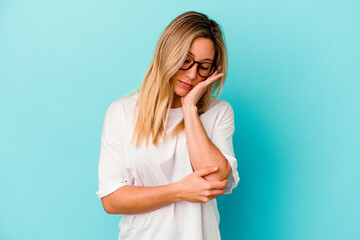 Young mixed race woman isolated on blue background who is bored, fatigued and need a relax day.