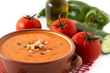 Gazpacho soup in crock pot and ingredients isolated on white background