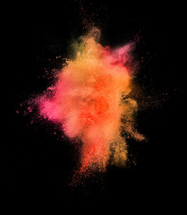 Explosion of colored, fluid and neoned powder on black studio background with copyspace