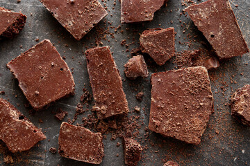 Dark chocolate on a dark background. Top view. Copy space. Chocolate background.