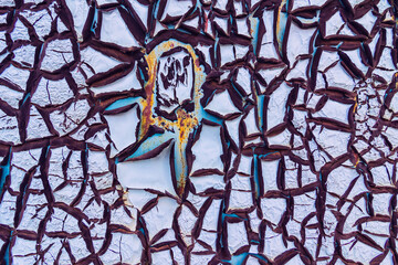 Abstract background of textured blue cracked wall.