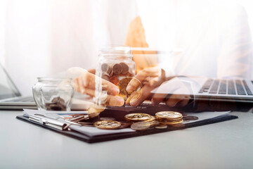 businessman holding coins putting in glass and using calculator. concept saving money and finance accounting.