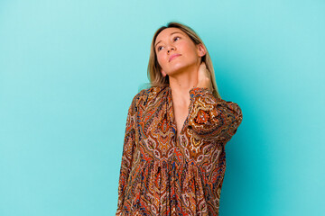 Young mixed race woman isolated on blue background having a neck pain due to stress, massaging and touching it with hand.
