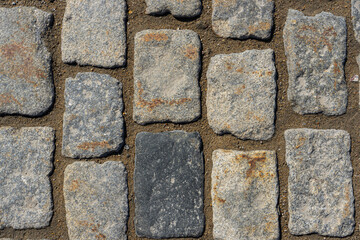 Background of granite cobblestone pavement.