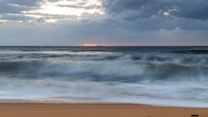 Sunrise at the seaside with a cloudy sky