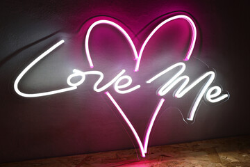 White and pink neon heart with the inscription love me. Trendy style. Wedding design Neon sign....