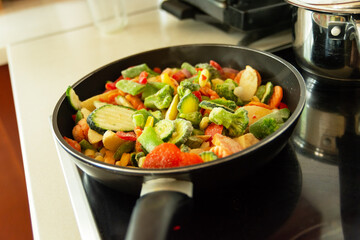 Frozen vegetables in a pan on an induction hob