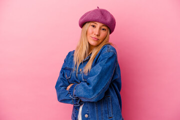 Young mixed race woman isolated on pink background dreaming of achieving goals and purposes