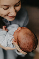 home photos of a newborn baby in the arms of mother. Selective focus, noise effect