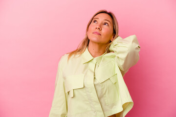 Young mixed race woman isolated on pink background having a neck pain due to stress, massaging and touching it with hand.