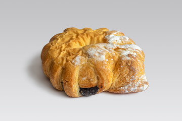 Golden-crusted custard bagel with poppy seeds and powdered sugar