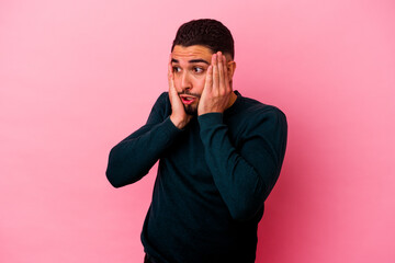 Young mixed race man isolated on pink background