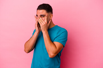 Young mixed race man isolated on pink background