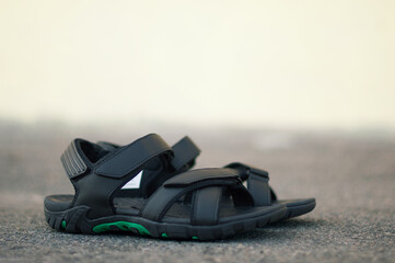 Black mens sandals on a background in the city