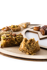 Assortment of Ramadan dessert baklava and dates isolated on white background