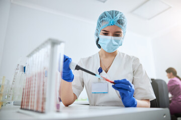 Experienced lab technician conducting a biochemical analysis