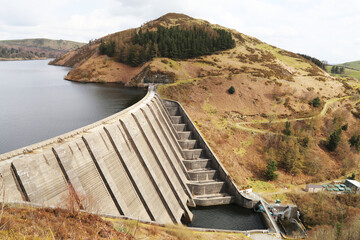 The high dam wall across the Llyn Clywedog reservoir in Powys, Wales, UK.