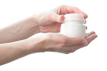 A woman holds a jar of hand cream