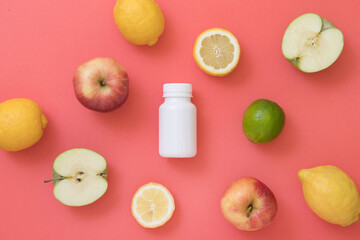 Bottle of pills with vitamins and natural fruits