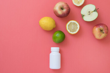 Vitamin bottle with fresh seasonal natural fruits