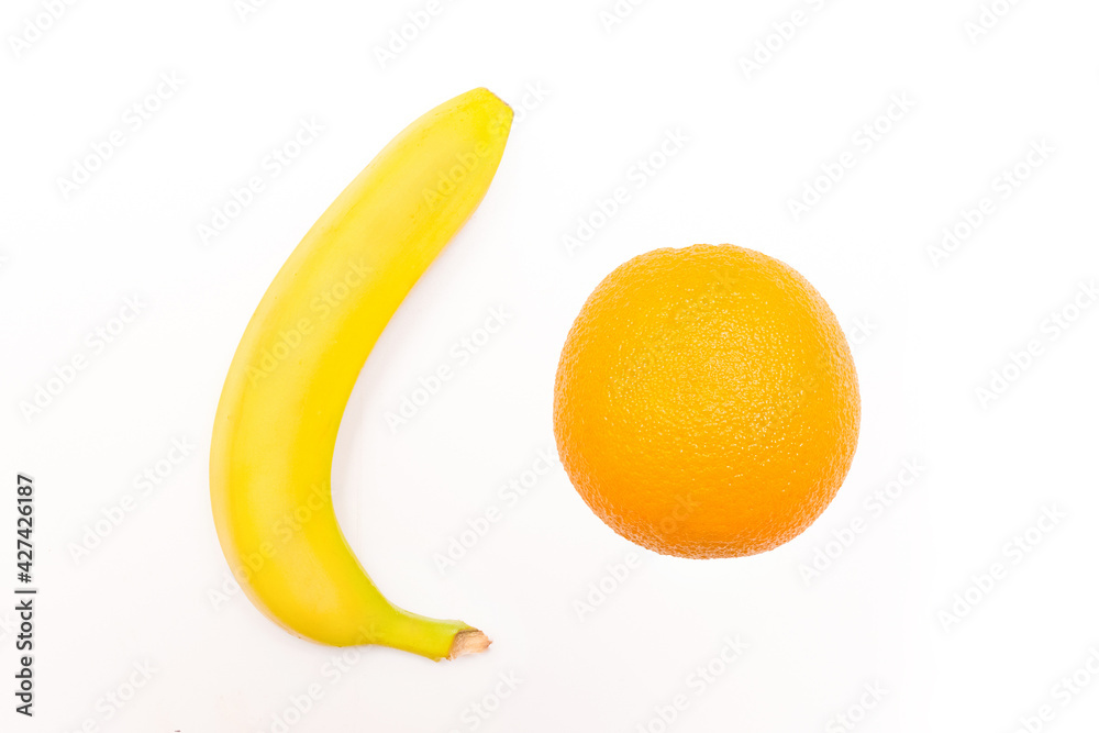 Wall mural Yellow banana and fresh orange isolated on white background