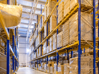 Interior of a modern warehouse storage with rows and goods boxes on high shelves