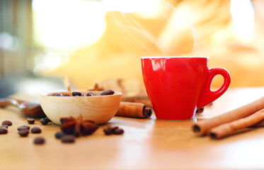 red cup of hot coffee with coffee beans backgroung