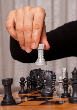 Woman playing chess game makes his move. Concept of business strategy and tactic.