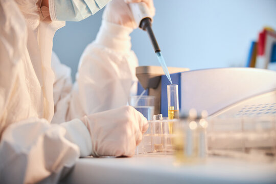 Woman in a face mask performing a chemical analysis