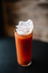 Glass of Bloody Maria cocktail decorated with rice crisps. Top view.