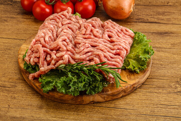 Raw pork minced meat over board