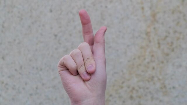 A man's hand clicks her fingers. Close up