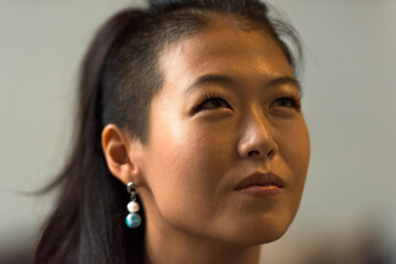 Close-up portrait of beautiful rebel Asian woman happy face thinking outdoors