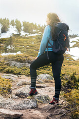 woman hiker standing in the mountain with sunlight.