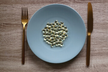 Vitamin D pills on a plate. Flat lay.