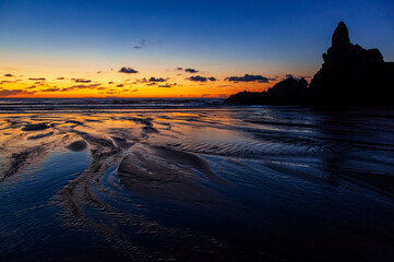 Zachód słońca na plaży Piha, Nowa Zelandia