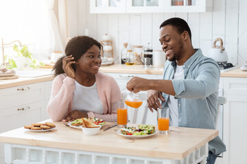 Obraz na płótnie Canvas Happy Young Millennial Spouses Chatting While Having Breakfast At Home Together