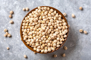 dry chickpeas in wooden bowl on concrete background Healthy eating, vegetable protein concept Top view Flat lay