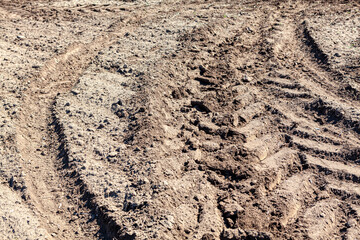 Tractor track on soil . Agricultural ground background