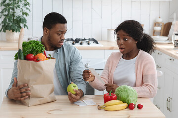 Shocking Prices. Frustrated African American Family Checking Bills After Grocery Shopping