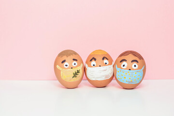 Creative Easter eggs with Corona virus (COVID19) protection concepts. Diverse chicken eggs with doodle faces wearing medical masks.