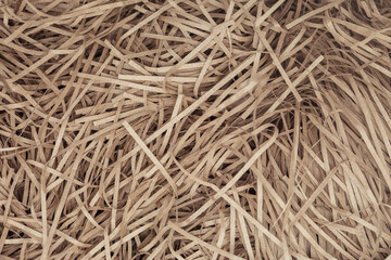 Brown color shredded paper - gift box filler background.