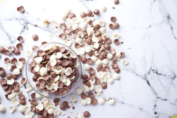  Top view of chocolate corn flakes in a bowl on tiles background 