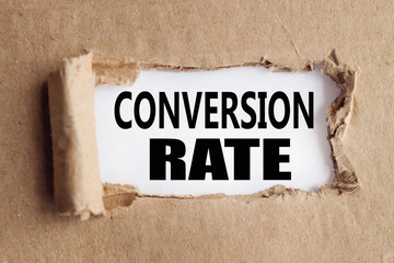 conversion rate.text on white paper over torn paper background.