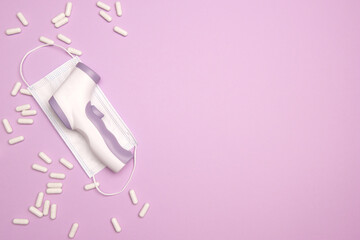 Non-contact infrared thermometer. Body Temperature Measurement Device. White capsule pills and...
