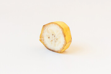 One slice of banana with peel isolated on white background. Skewed view